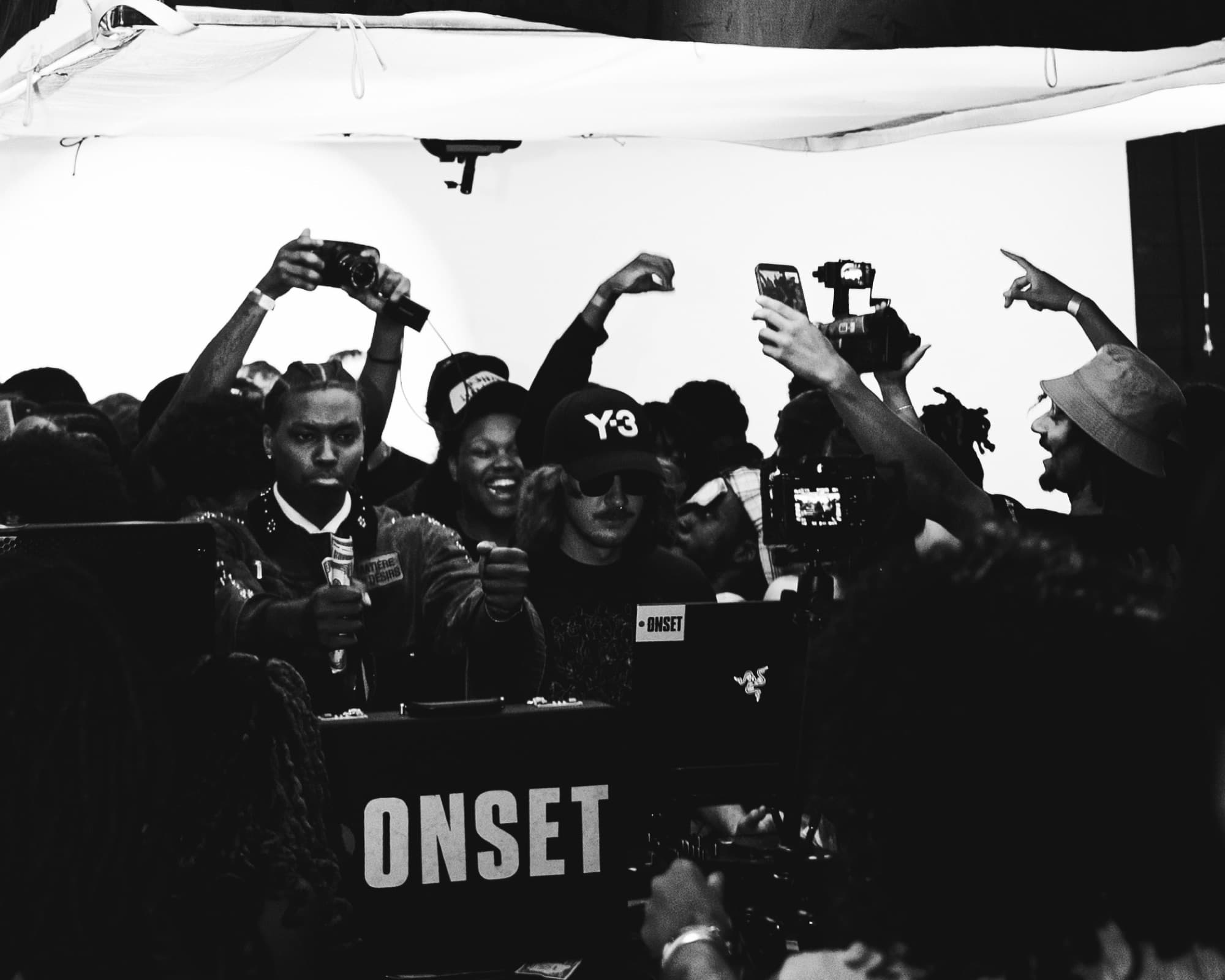 A crowd posing behind an ONSET box, in black and white