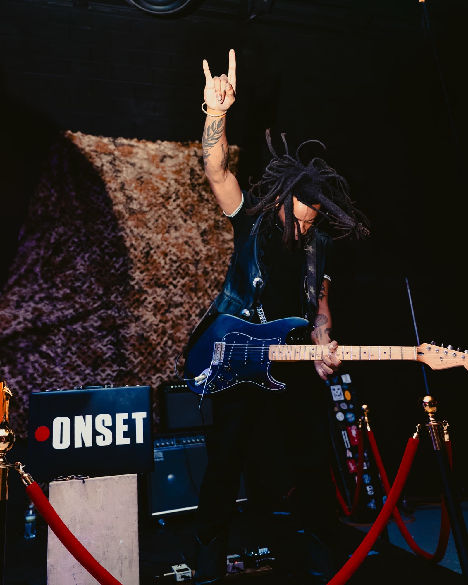 A guitarist playing live through an ONSET-branded amp at ONSET²