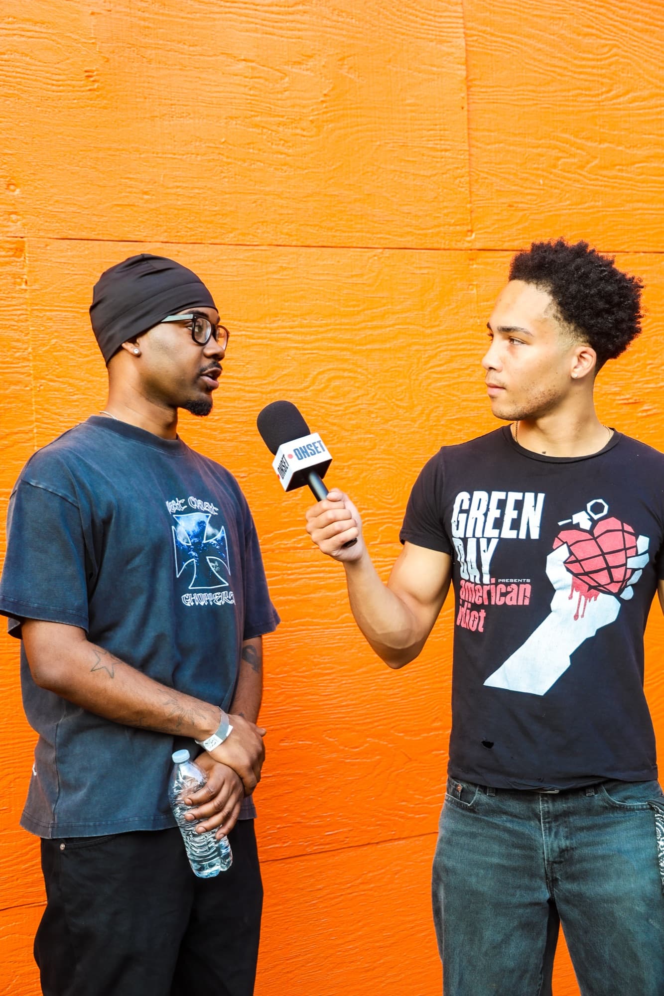 A mic-flag interview against an orange wall at Sunnee Day