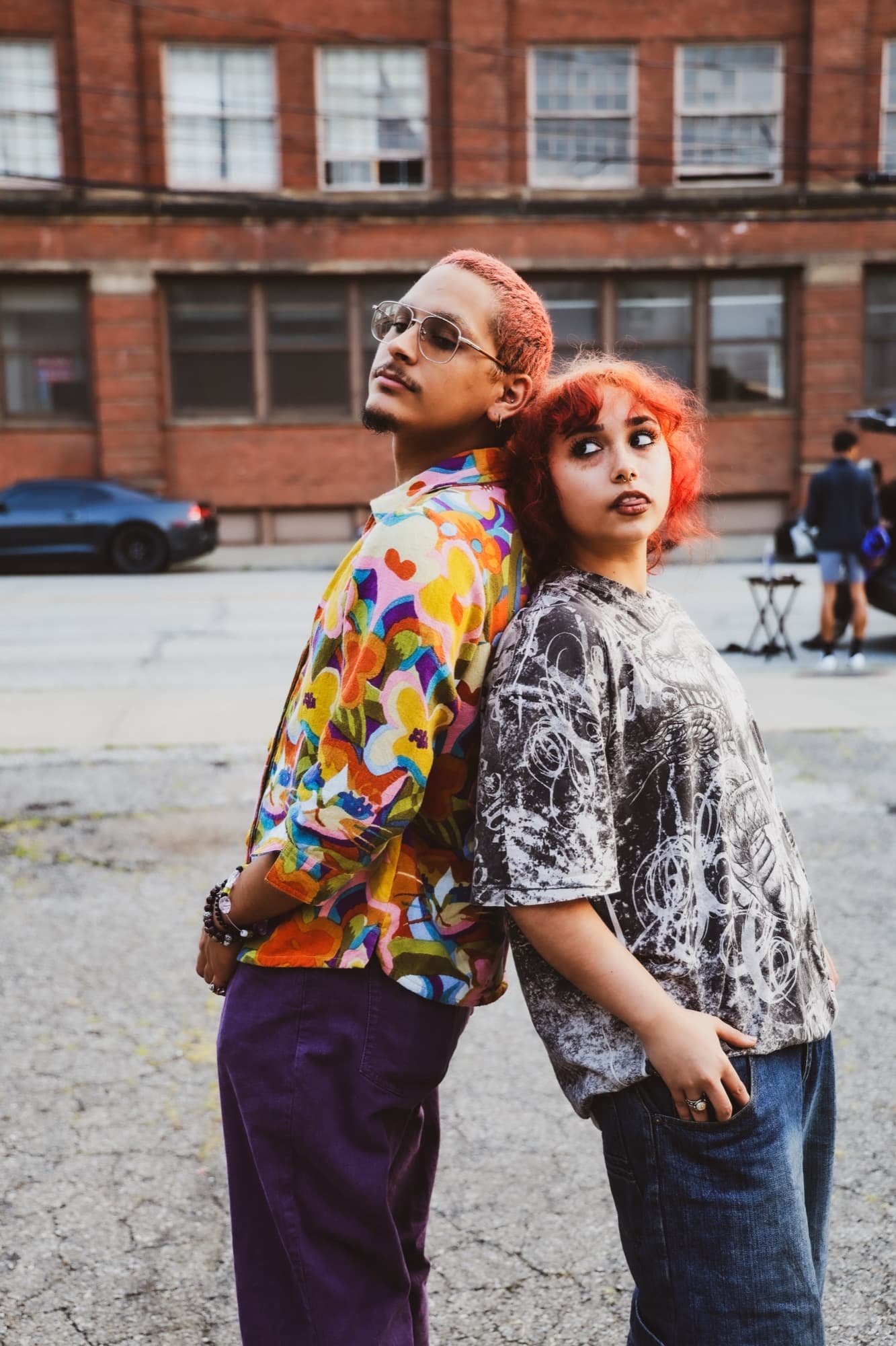 Two friends posed back to back on a Cleveland street