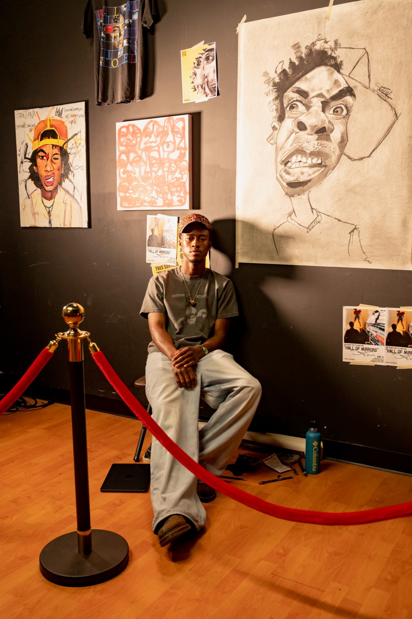 An artist standing beside his drawings at ONSET One