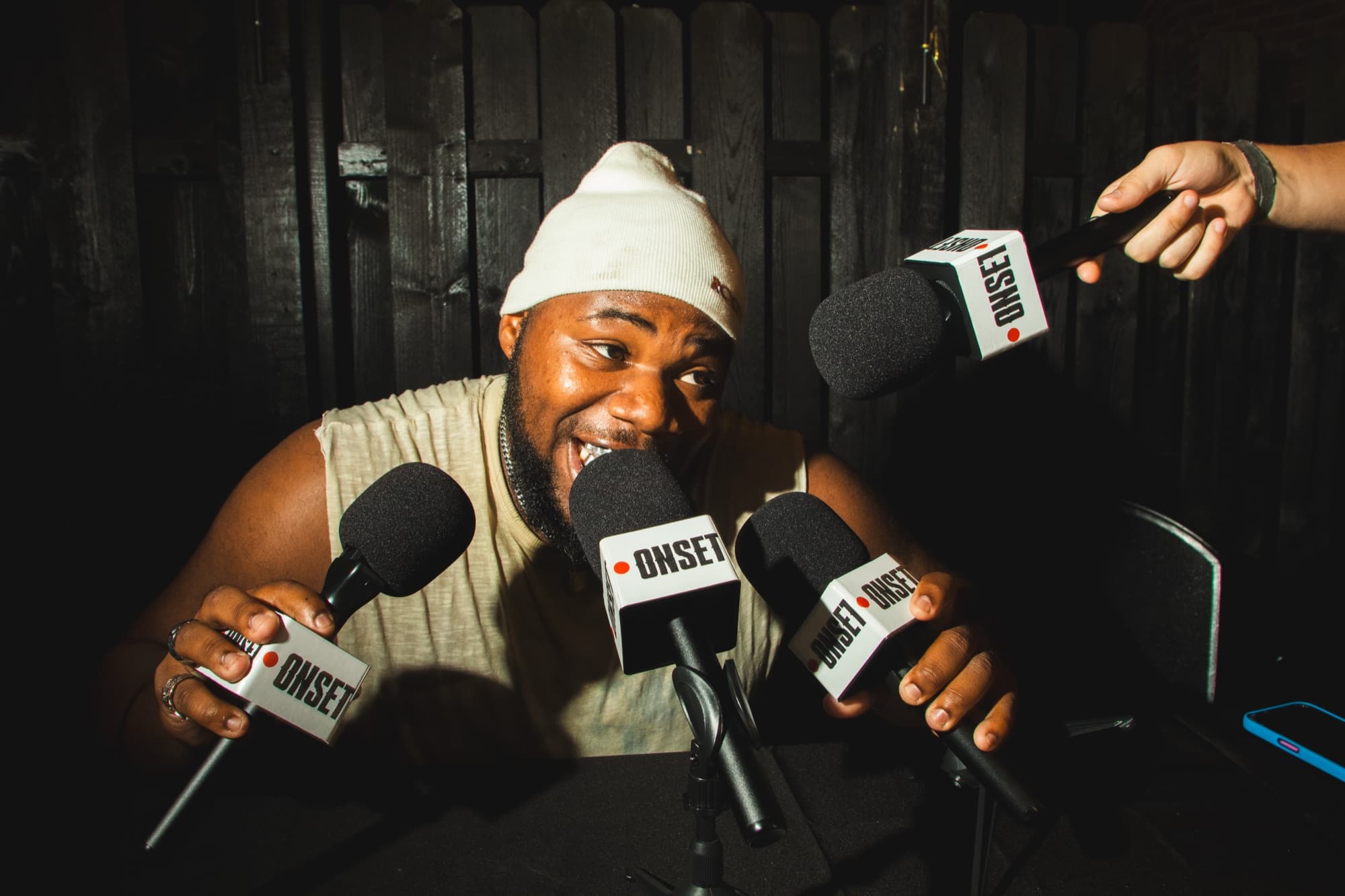 A guest answering questions into three mic flags